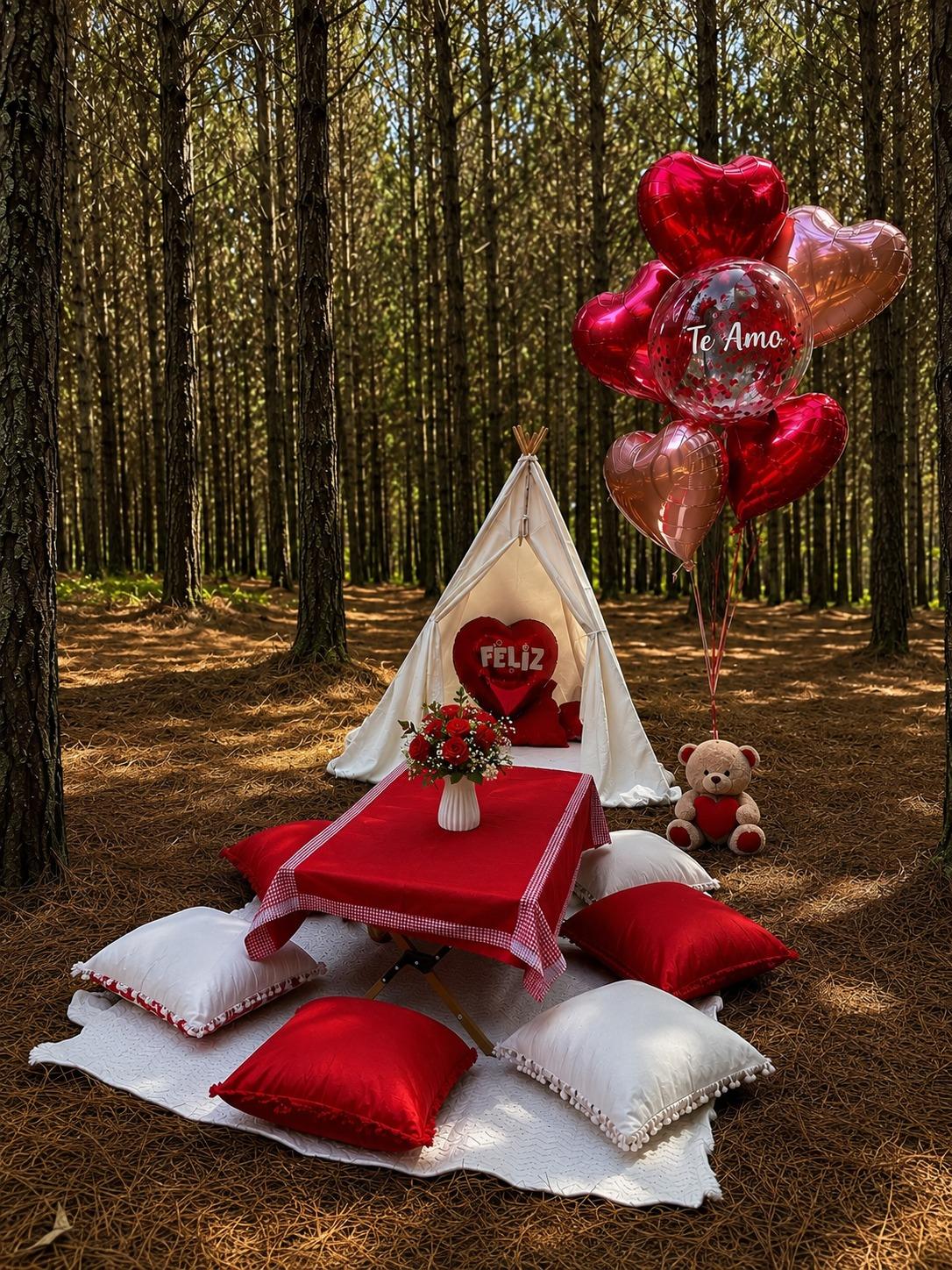 Picnic romántico en el bosque con mantel rojo, globos de corazón y un oso de peluche